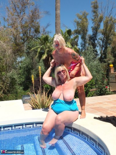 Older blonde pumpers Randy Raz and Melody indulge in lesbian play at the pool Gallery Cover Image
